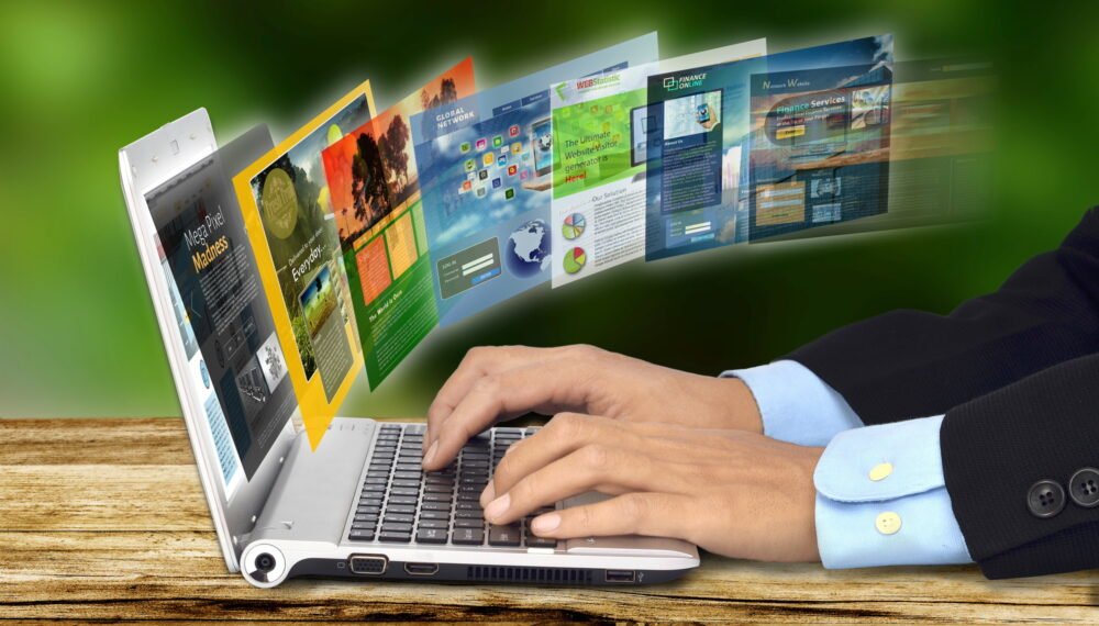 Businessman hand browsing internet websites on his laptop